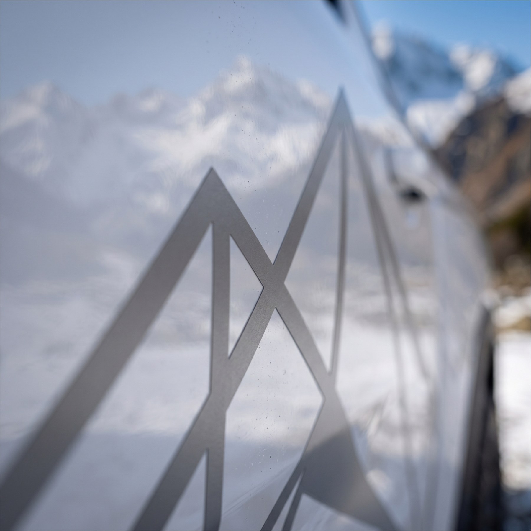 Close-up of subtle silver vinyl mountain graphic on vehicle paint